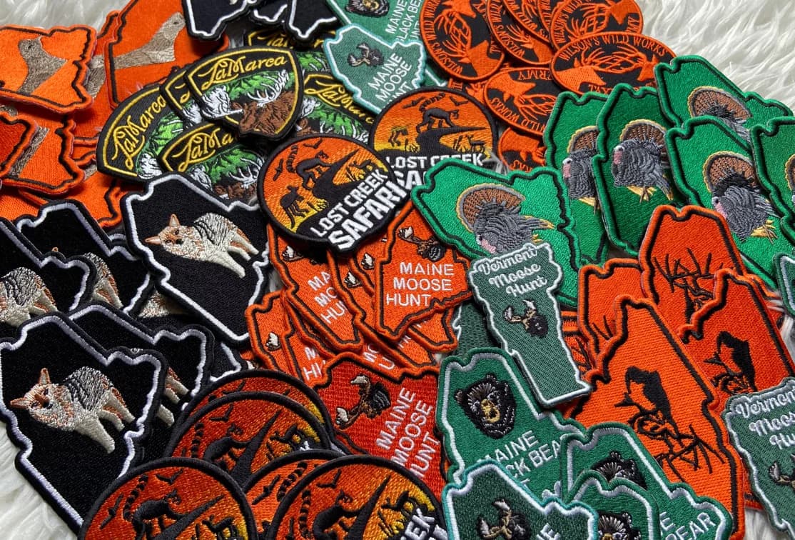 Orange, black and green wildlife-themed patches